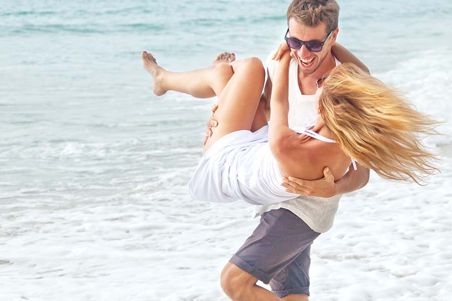 Romantic couple on beach proposing